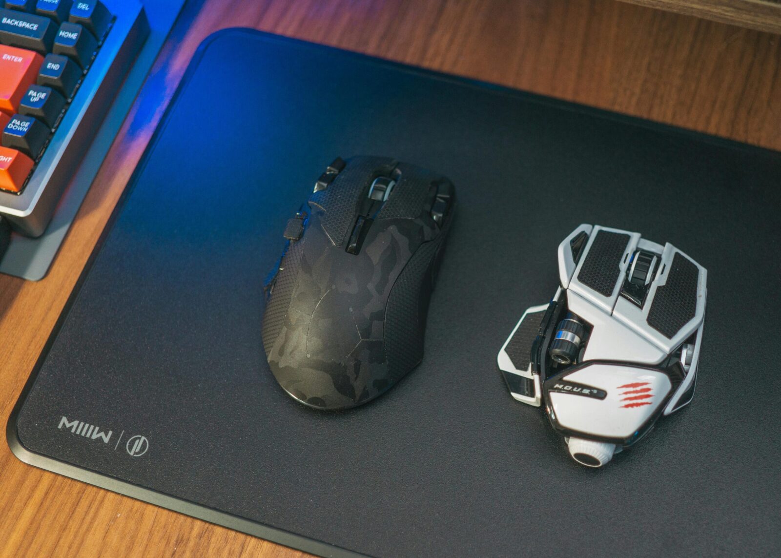 Close-up of two wireless gaming mice on a desk, showcasing modern technology.